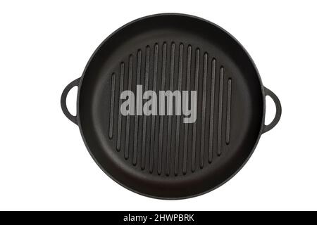 Empty cast iron grill frying pan isolated on white background with clipping path. Top view. Stock Photo