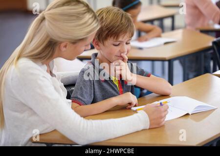 Enriching eager young minds. A young teacher in her classroom. Stock Photo