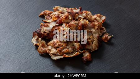 Shawarma gyro. Greek, Turkish traditional meat food on black color background, above view. Ethnic dish, meat cut into thin slice, Middle East popular Stock Photo