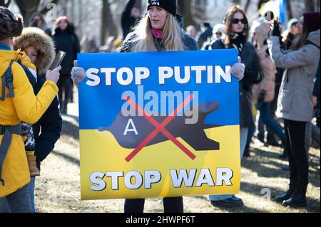 Riga, Latvia - March 05, 2022: Protest against war in Ukraine and Russia's invasion. Crowd of people with flags, signs and posters at demonstration Stock Photo