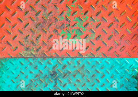 Stair steps are made of iron plate painted in orange and green Stock Photo