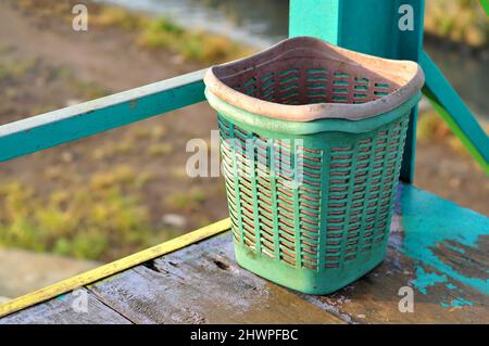 Small green trash can made of plastic Stock Photo