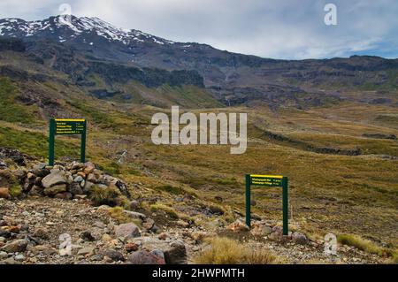 Directional signs for hikers on the slopes of Mount Ruapehu, the highest volcano of New Zealand, in Tongariro National Park, a World Heritage area.