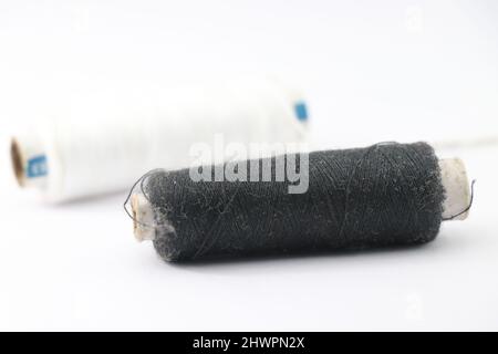 Sewing threads of colors black and white isolated on white background Stock Photo