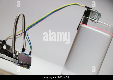Water level monitoring system using Ultrasonic sensor and some microcontroller shows readings on OLED by measuring the level of water on glass Stock Photo