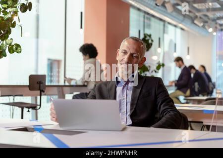 Manager working on laptop in office Stock Photo