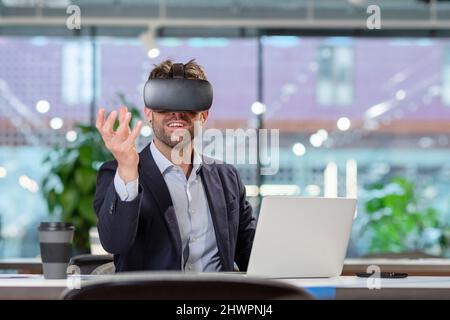 Businessman with VR googles gesturing in office Stock Photo