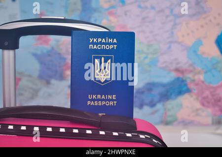 Ukrainian international passport and world map refugee concept . High quality photo Stock Photo