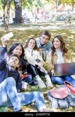 Multiracial students spending leisure time on university campus Stock Photo