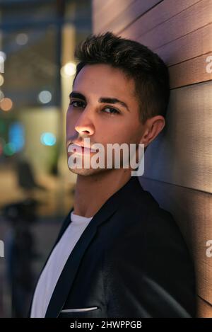 Handsome businessman leaning on wall Stock Photo