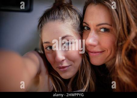 Smiling female friends taking selfie Stock Photo