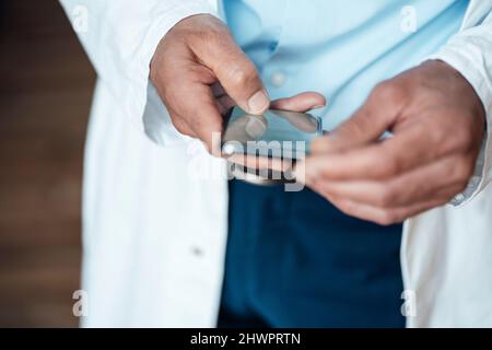 Doctor using smart phone in hospital Stock Photo