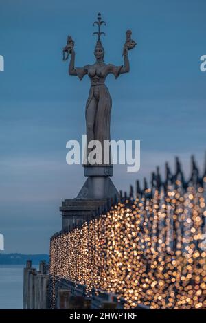 Germany, Baden-Wurttemberg, Konstanz, Statue of Imperia with Christmas lights in foreground Stock Photo