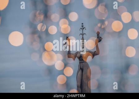 Germany, Baden-Wurttemberg, Konstanz, Statue of Imperia with Christmas lights in foreground Stock Photo
