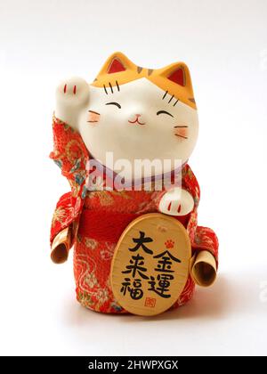 Maneki neko. Typical Japanese cat of fortune. Stock Photo