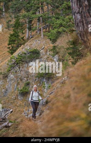 Senior woman hiking in mountain Stock Photo