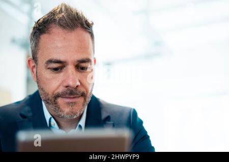 Businessman using tablet PC at workplace Stock Photo