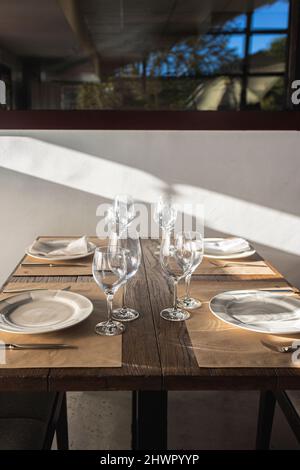 Plates and wineglasses on table in restaurant Stock Photo