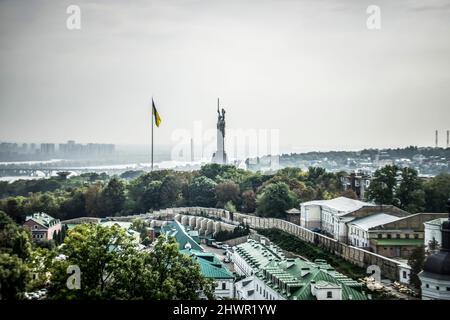 Kiev, Ukraine – October 10th, 2020: Panoramic view of Kiev with the Motherland Monument and Ukrainian flag visible in the background Stock Photo