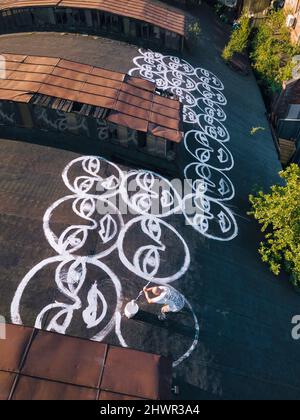Artist painting graffiti on rooftop Stock Photo