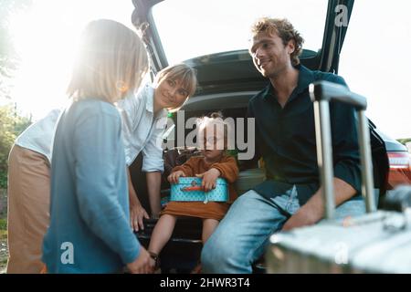 Smiling parents looking at son on vacation Stock Photo