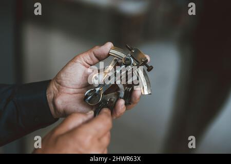 Senior man holding measuring tool Stock Photo