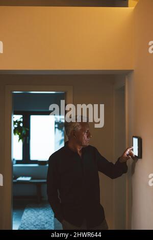 Senior man using tablet PC at smart home Stock Photo