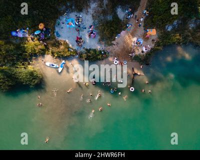 overhead view of leak beach blue water. people having fun swimming