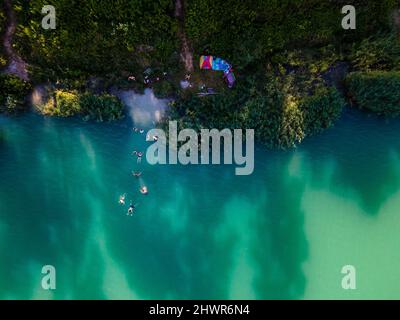 overhead view of leak beach blue water. people having fun swimming