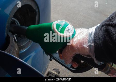 Ashford, Kent, UK. 7th Mar, 2022. A petrol station in Ashford, Kent is now charging over £1.67 per litre of diesel as a barrel of oil hits $130. A man fills up his car with E10 unleaded petrol fuel at the pump. Stock Photo