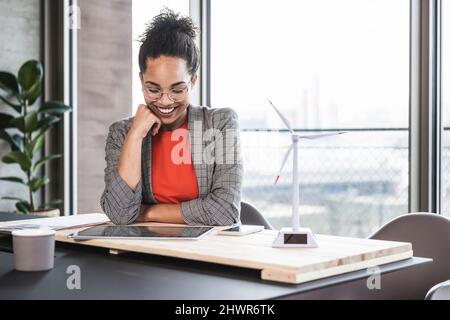 Smiling businesswoman using tablet PC in office Stock Photo