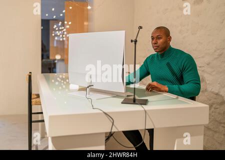 Man using computer working from home Stock Photo