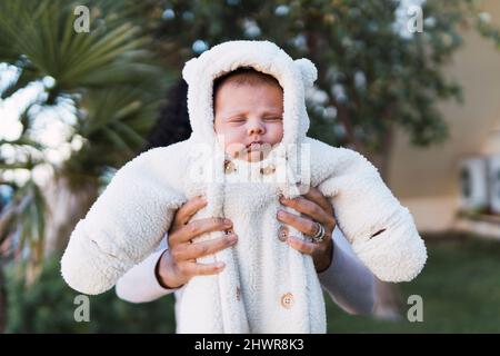 Mother holding cute son in garden Stock Photo