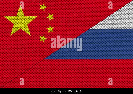 Conflict between Russia and People's Republic of China war concept. Russian flag and China flag background. Flag with texture of thread and rope. Stock Photo