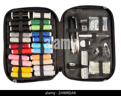 Travel sewing kit with spools of sewing thread, scissors, needles and spare buttons, on white background Stock Photo
