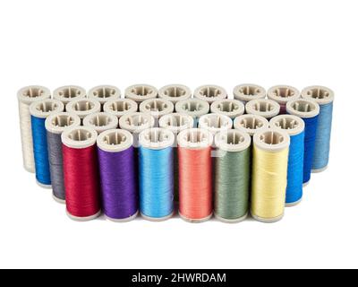 Assortment of spools with colored sewing thread on white background Stock Photo