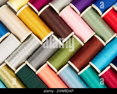 Assortment of spools with colored sewing thread on white background Stock Photo