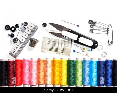 Travel sewing kit with spools of sewing thread, scissors, needles and spare buttons, on white background Stock Photo