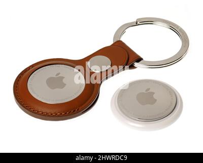 Bucharest, Romania - March 6, 2022: Apple Air Tags with brown leather keychain, on white background Stock Photo