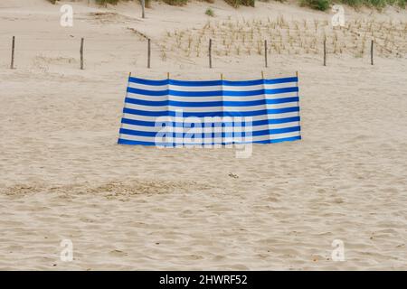 Blue and white striped cotton for shadow on beach Stock Photo
