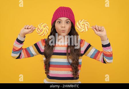 making face. lollipop lady. hipster kid with colorful lollypop sugar candy on stick. caramel candy Stock Photo