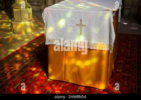Colorful light spots on the altar and the floor in church. Sunlight filtered through the stained glass window. A game of light and shadow. Stock Photo