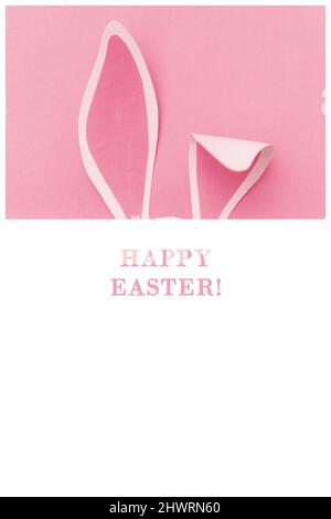 Bunny ears on a pink background with the inscription Happy Easter! Easter card, minimalism. Stock Photo