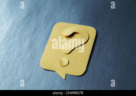 Question mark on yellow speech bubble, gray background. Problem and solution concept. Brainstorm. Stock Photo