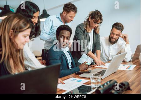 Multiethnic colleagues working on project Stock Photo