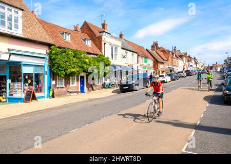 Cyclists riding down West Street, New Alresford, Hampshire, England UK Stock Photo