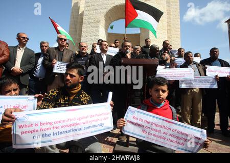 Rafah, Gaza. 07th Mar, 2022. Palestinians lift placards during a rally demanding international support for Palestinians against Israel at the Rafah refugee camp in the Gaza Strip on Monday, March 7, 2022. The placards are similar to those shown for Ukrainians against Russia. Photo by Ismael Mohamad/UPI Credit: UPI/Alamy Live News Stock Photo
