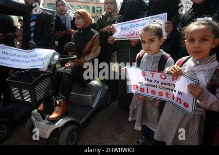 Rafah, Gaza. 07th Mar, 2022. Palestinians lift placards during a rally demanding international support for Palestinians against Israel at the Rafah refugee camp in the Gaza Strip on Monday, March 7, 2022. The placards are similar to those shown for Ukrainians against Russia. Photo by Ismael Mohamad/UPI Credit: UPI/Alamy Live News Stock Photo