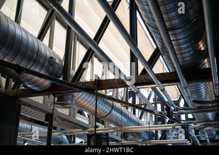 Ceiling structure with steel ventilation pipe and shiny pipe systems Stock Photo
