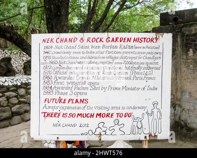 India, Punjab and Haryana, Chandigarh. Nek Chand's Rock Garden of scraps & recycled materials made sculpture. Information boards. Stock Photo